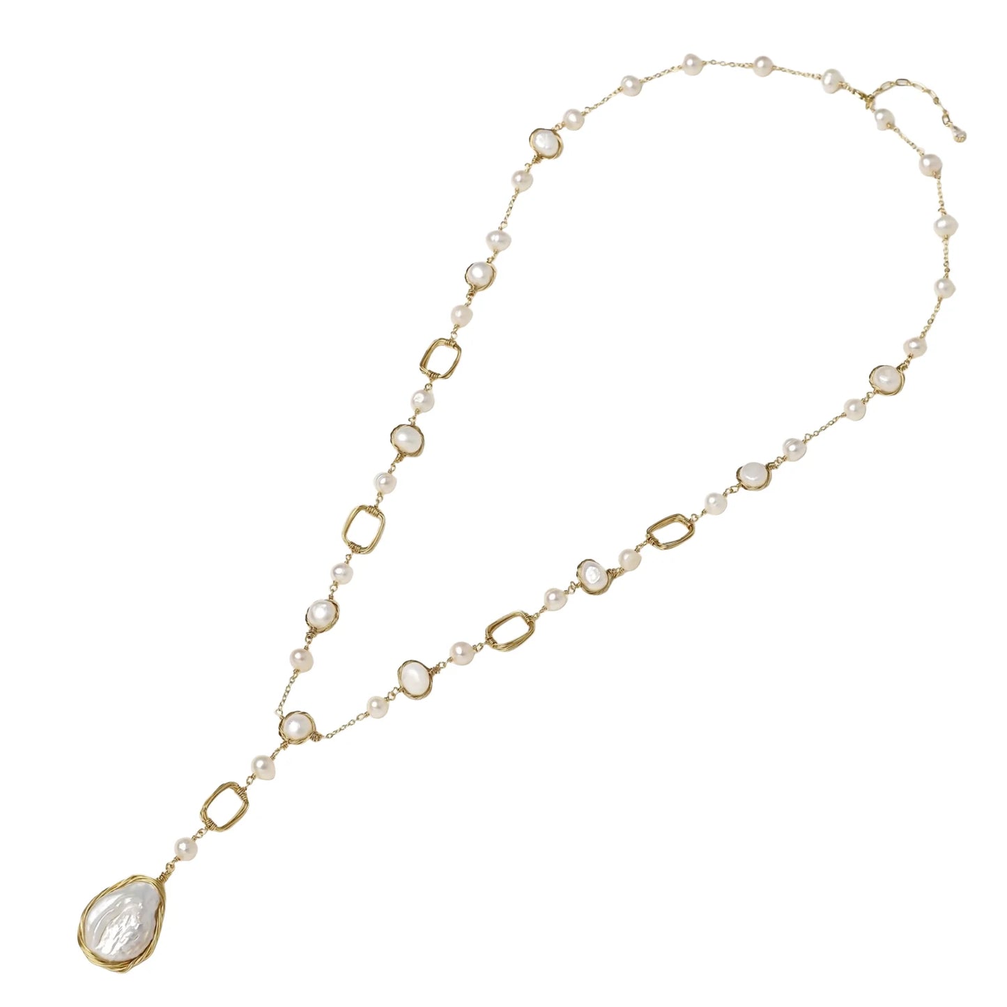 Y-shaped gold necklace with alternating geometric links, freshwater pearls, and baroque pearl pendant on cream background