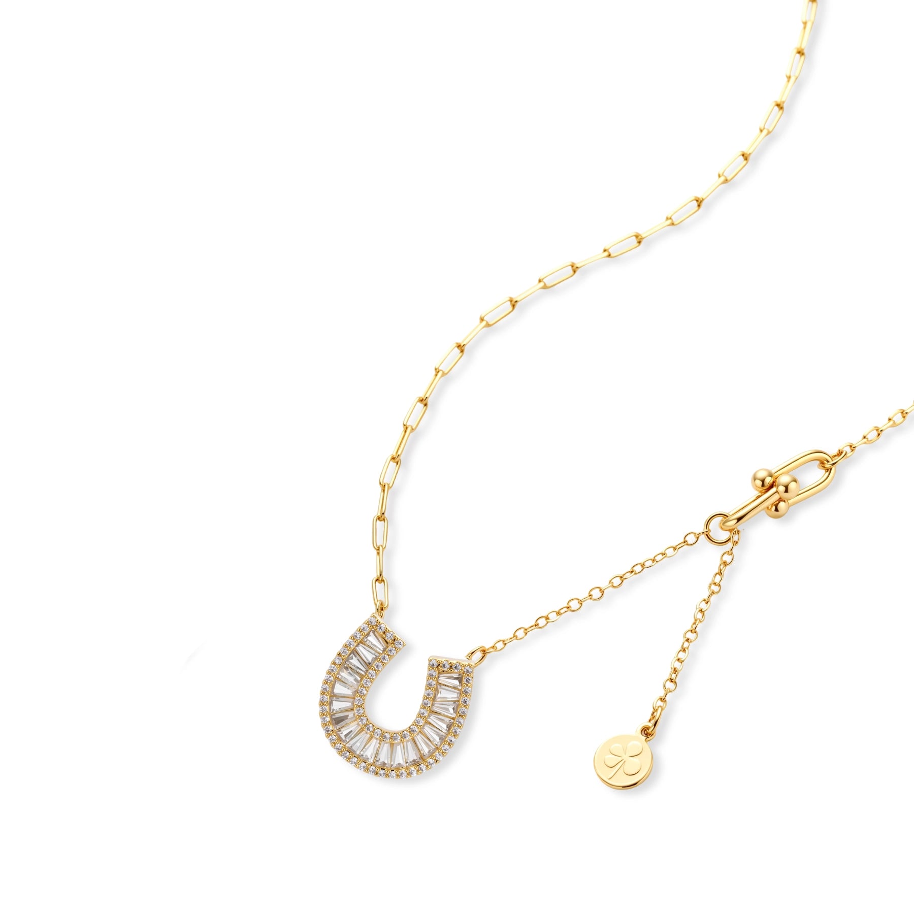 Sparkling horseshoe-shaped jewelry set with AAA cubic zirconia in gold-plated and white gold finishes on cream background.