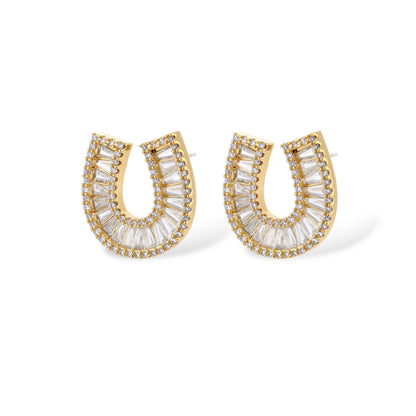 Sparkling horseshoe-shaped jewelry set with AAA cubic zirconia in gold-plated and white gold finishes on cream background.
