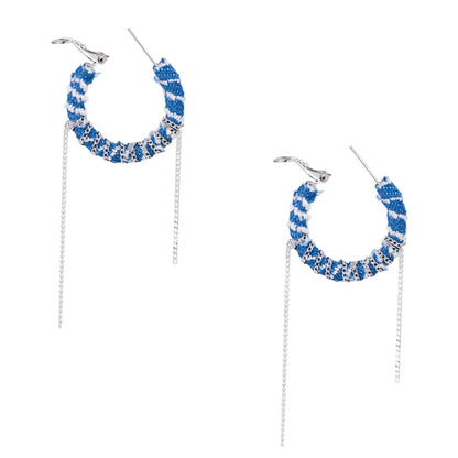 Medium hoop earrings wrapped in blue striped denim fabric with dangling silver chains on white background.