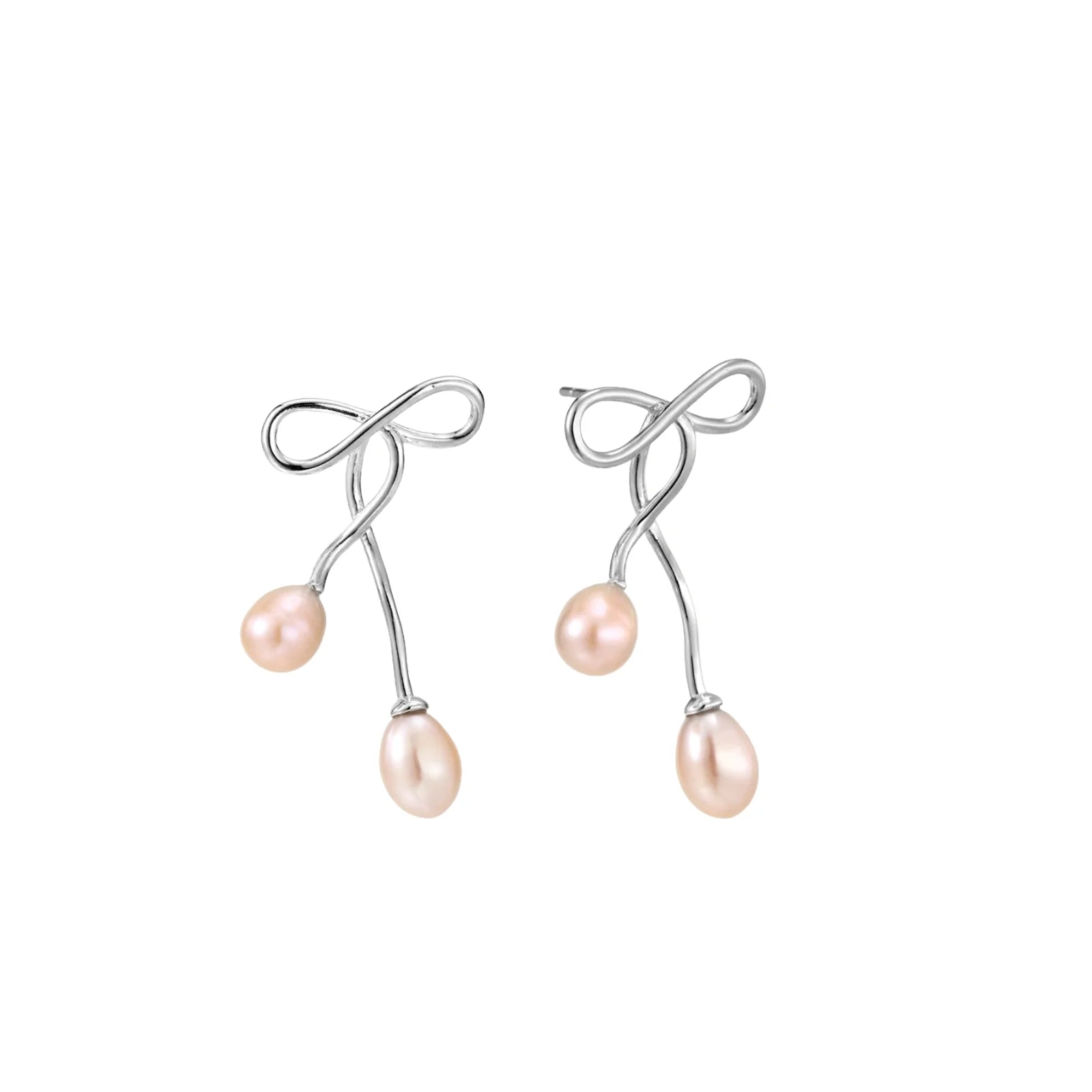 Rhodium-plated silver earrings with organic vine curves and two peachy freshwater pearls on cream background