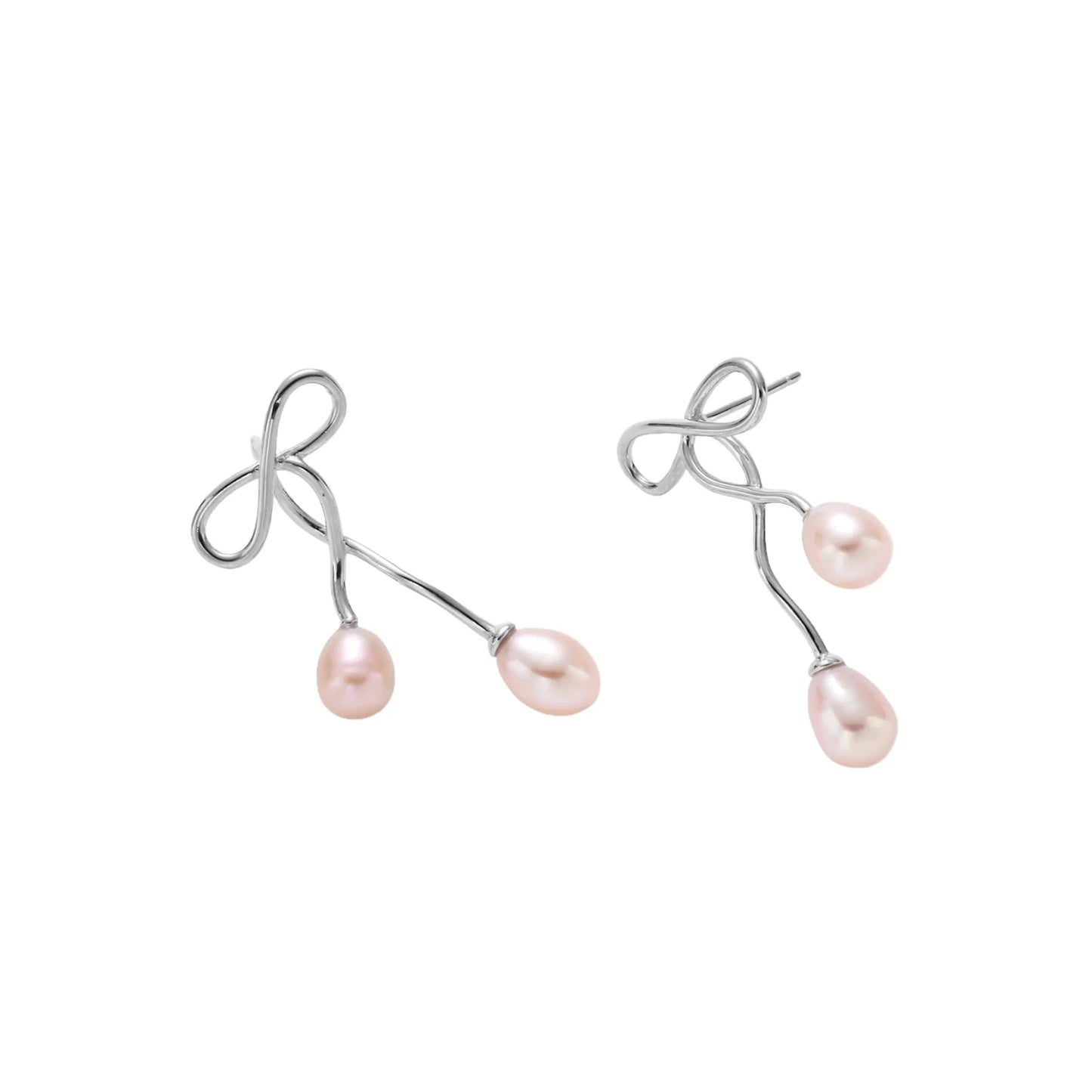Rhodium-plated silver earrings with organic vine curves and two peachy freshwater pearls on cream background