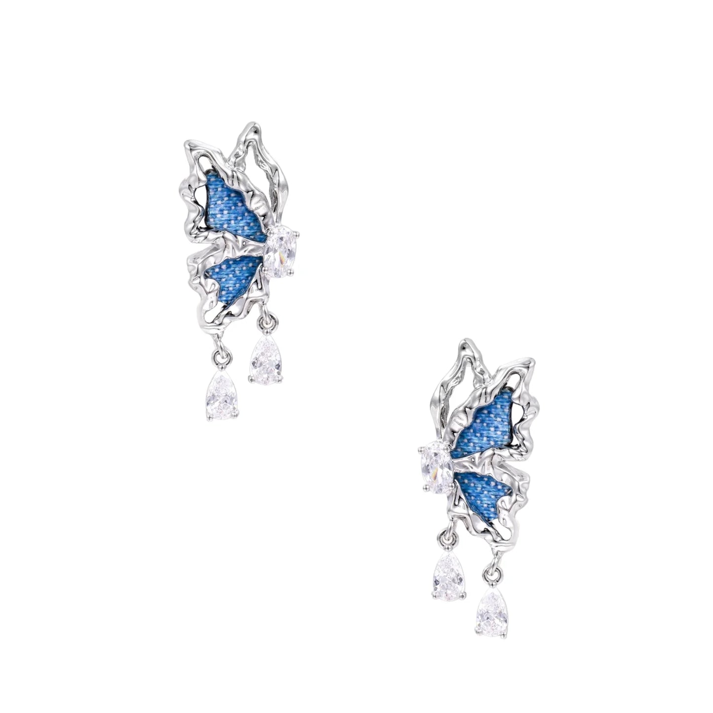 Silver butterfly earrings with blue denim fabric wings and dangling teardrop crystals on cream background