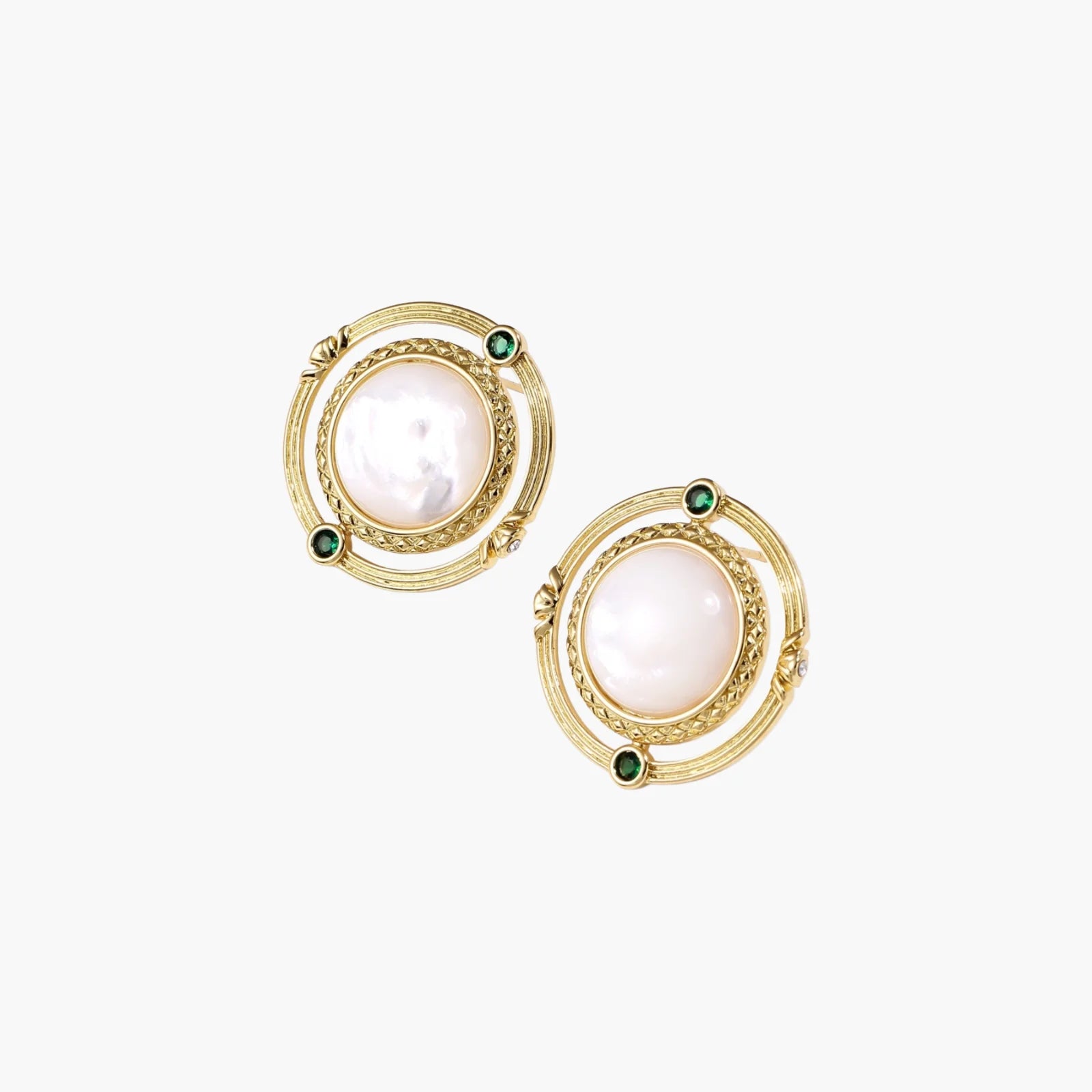Circular gold stud earrings with iridescent mother-of-pearl center and green zirconia accents on cream background.