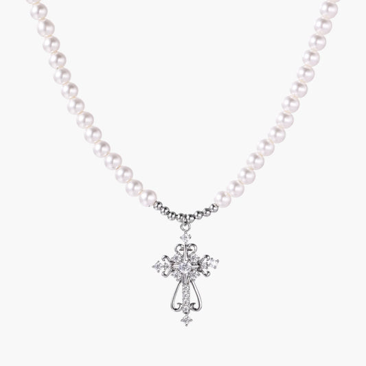 White pearl beaded necklace with ornate crystal-embellished cross pendant on white background, white gold plated finish