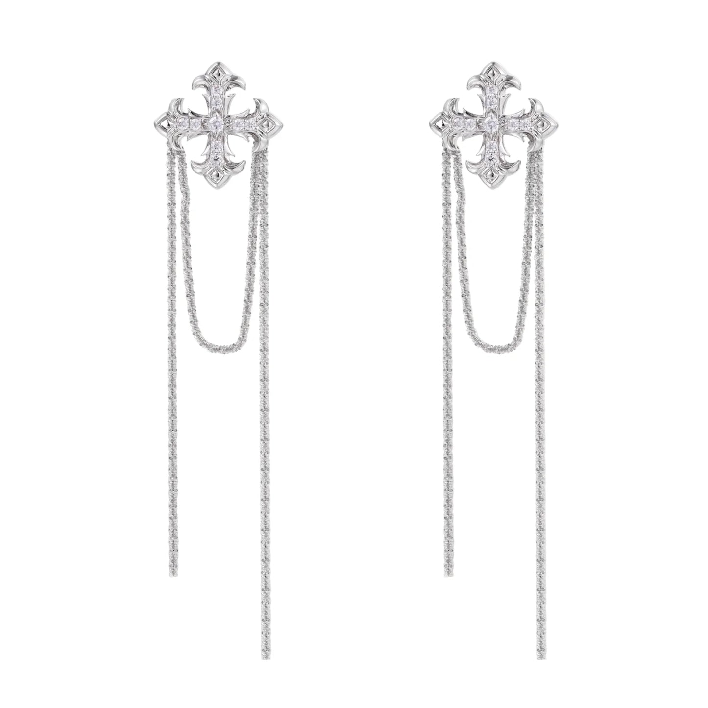 White gold plated baroque cross stud earrings with long cascading zirconia chains on cream background