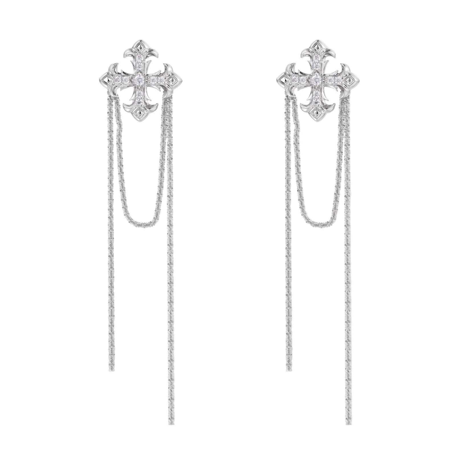 White gold plated baroque cross stud earrings with long cascading zirconia chains on cream background