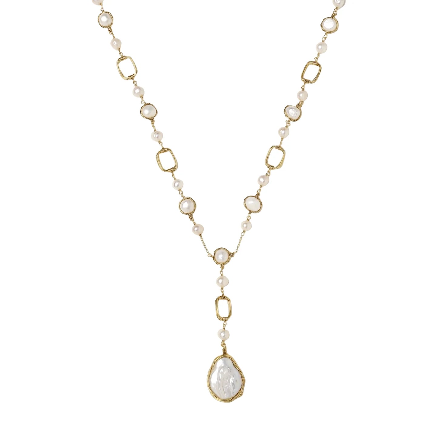 Y-shaped gold necklace with alternating geometric links, freshwater pearls, and baroque pearl pendant on cream background