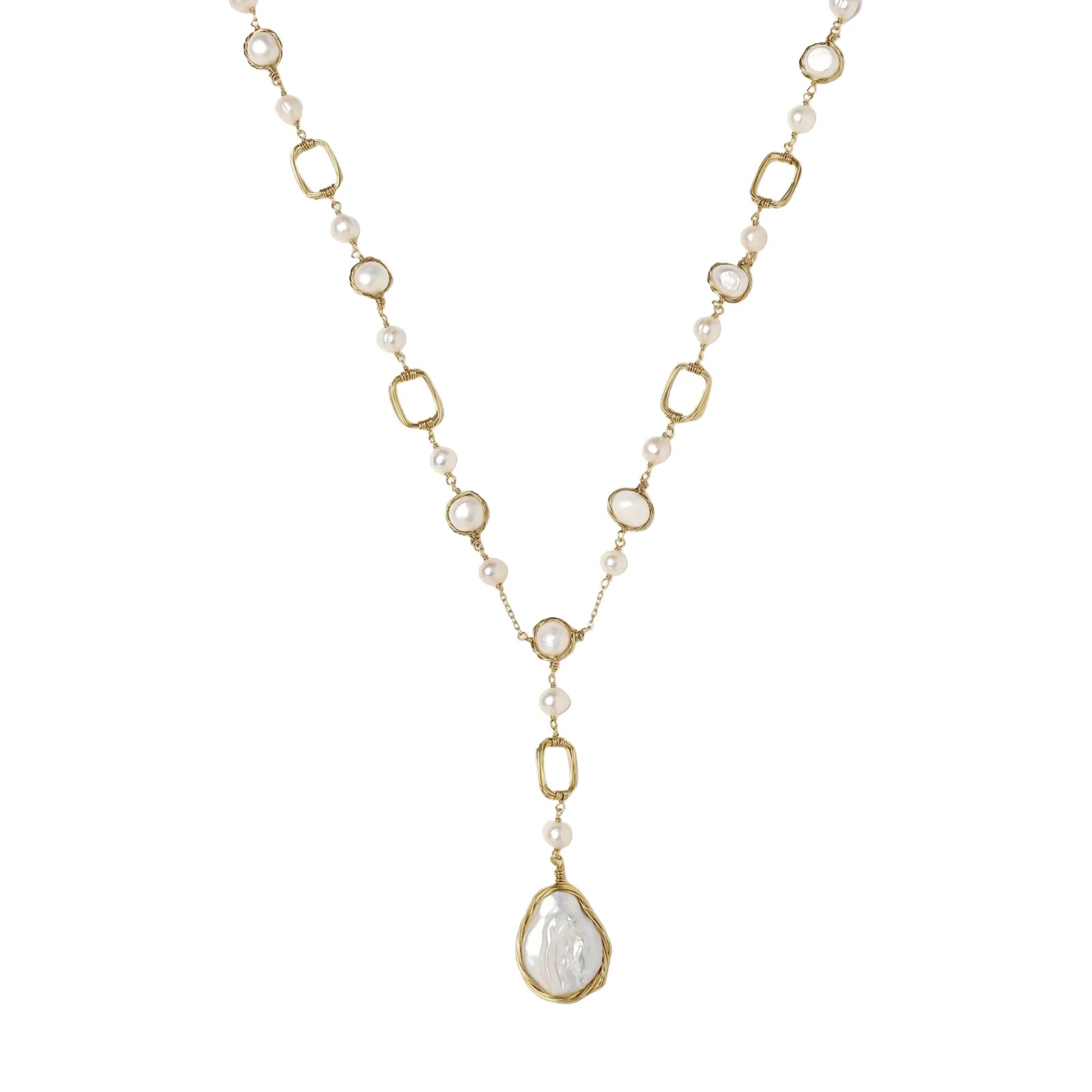 Y-shaped gold necklace with alternating geometric links, freshwater pearls, and baroque pearl pendant on cream background