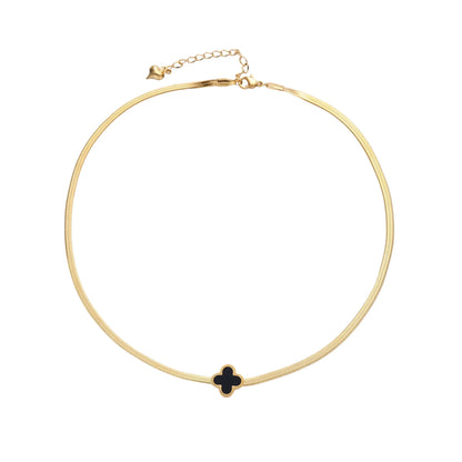 Dainty 18K gold-plated herringbone chain necklace with black enamel quatrefoil clover pendant on white background