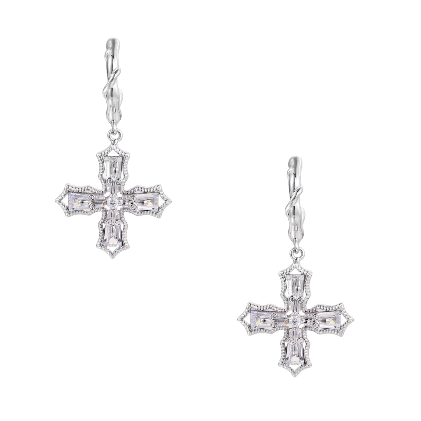 Ornate white gold-plated cross earrings with baguette-cut zirconia stones and twisted leverback hooks on beige background