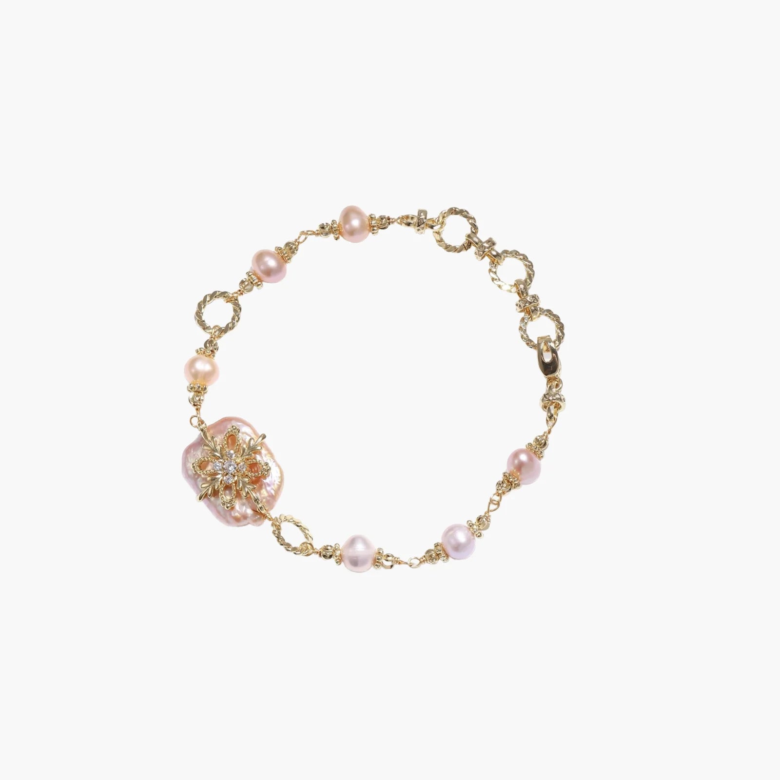 Gold-plated bracelet with pink baroque pearl centerpiece, floral connector, and freshwater pearls