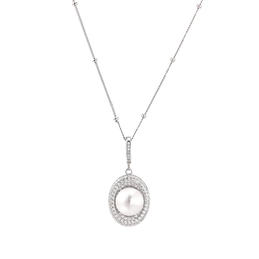Oval sterling silver pendant with crystal halo surrounding a white freshwater pearl on delicate chain