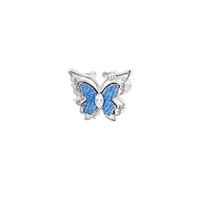 Silver-toned ring with blue denim butterfly wings, marquise zirconia center, and ornate scrollwork band on white background