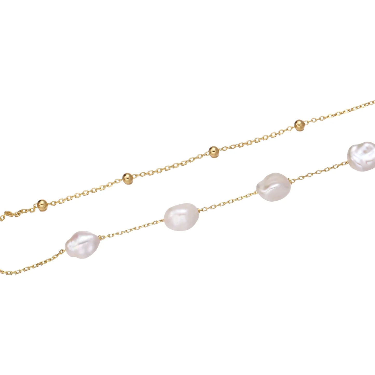 Double-strand gold bracelet with irregular baroque pearls and smooth freshwater pearls on cream background.