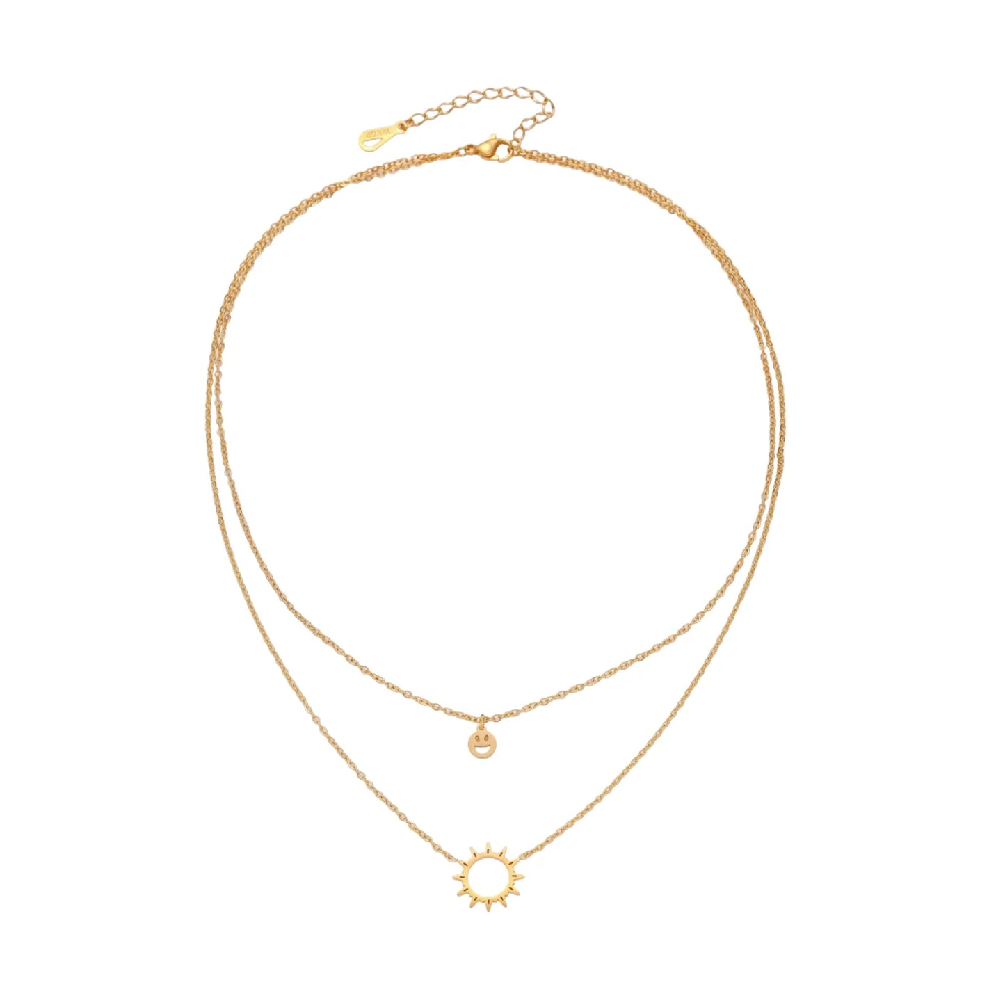 Gold layered necklace set with sunburst and smiley face pendants on delicate chains against white background.