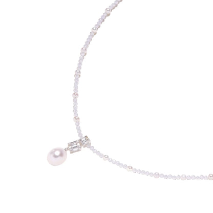 Dainty necklace with lavender crystal beads, freshwater pearls, geometric pendant, and large pearl drop on white background.