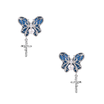 Royal blue denim butterfly earrings with white pearl centers and silver cross charms on white background