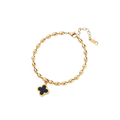 18K gold-plated oval bead chain bracelet with quatrefoil clover charm featuring mother of pearl inlay on cream background