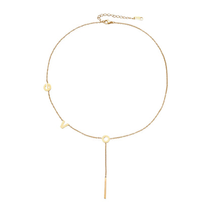 Gold Y-shaped necklace with L-O-V-E letter charms and vertical bar pendant on delicate chain against cream background