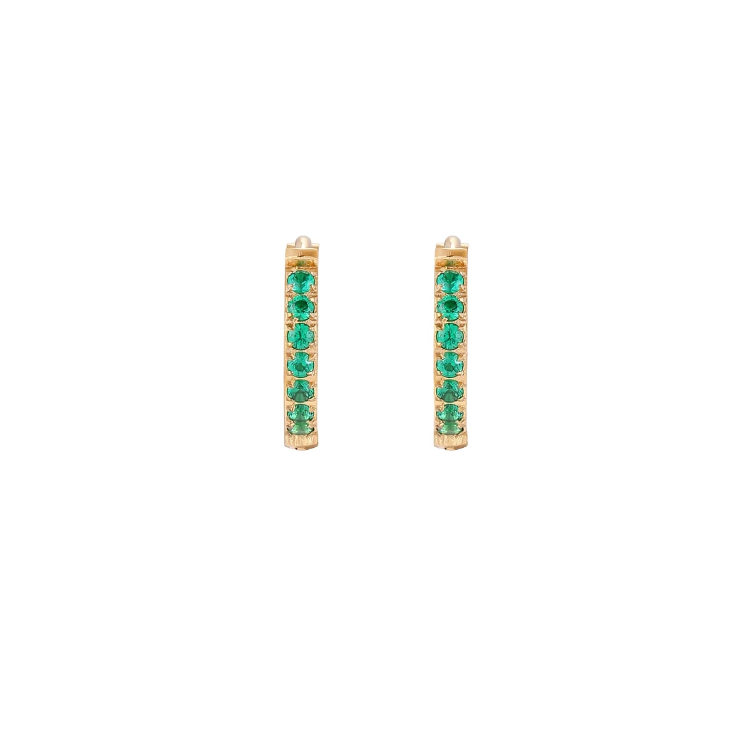Pair of small gold huggie hoop earrings with bright green cubic zirconia stones on cream background