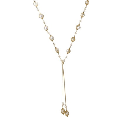 Adjustable gold lariat necklace with freshwater pearls nested in delicate cage settings and Y-shaped tassel drop
