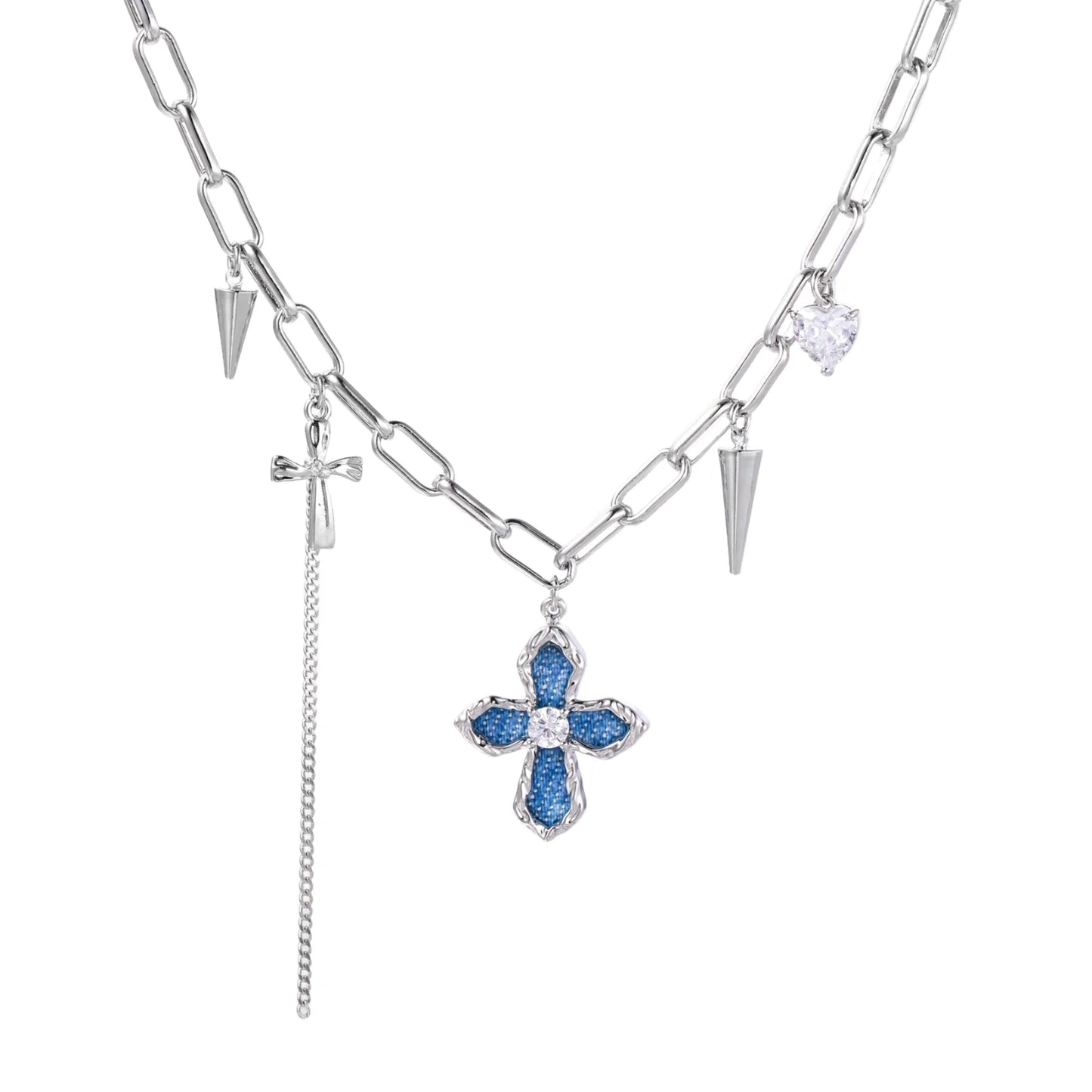 White gold plated chain necklace with blue textured cross pendant, spike charms, and mini cross detail on beige background