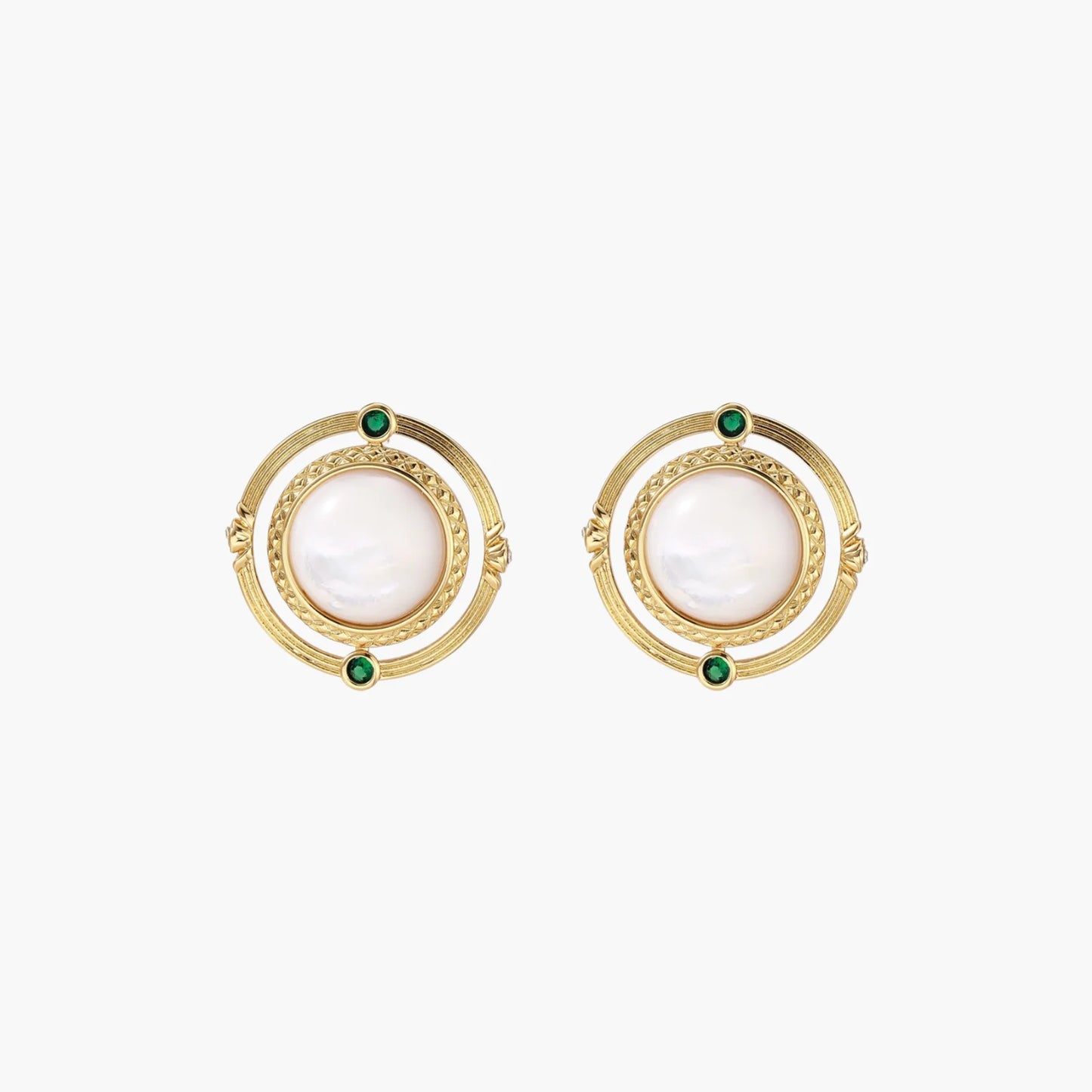 Circular gold stud earrings with iridescent mother-of-pearl center and green zirconia accents on cream background.
