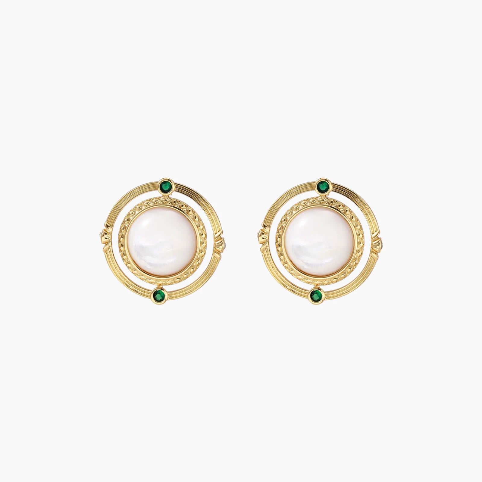 Circular gold stud earrings with iridescent mother-of-pearl center and green zirconia accents on cream background.