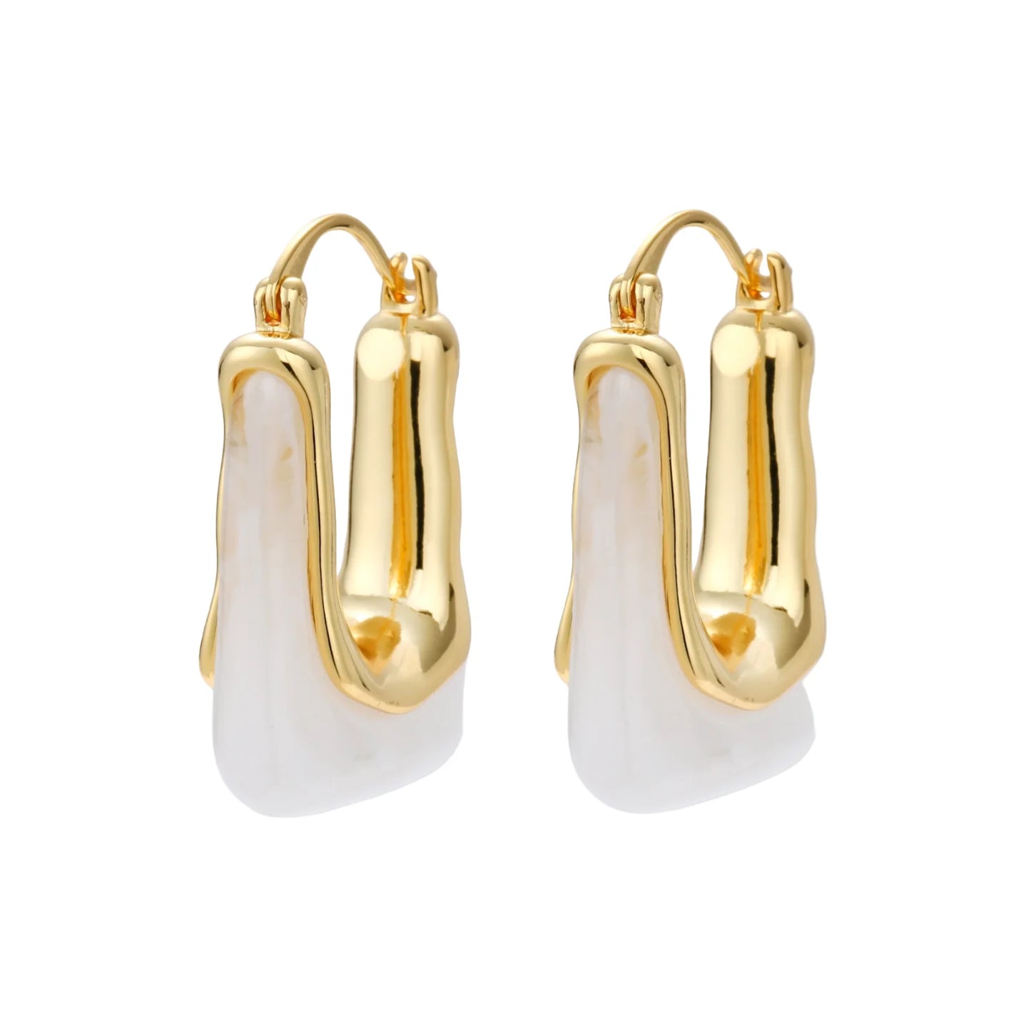 Sculptural gold-plated hoop earrings with flowing curved design and lever-back closure on cream background.
