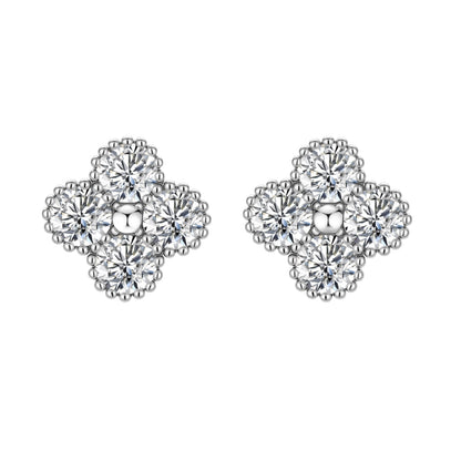 Dainty sterling silver quatrefoil stud earrings with four brilliant moissanite stones and center accent on white background.