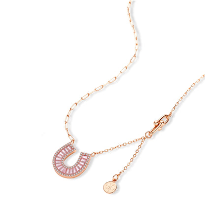 Sparkling horseshoe-shaped jewelry set with AAA cubic zirconia in gold-plated and white gold finishes on cream background.