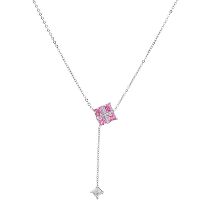 White gold plated jewelry set with pink cubic zirconia stones in geometric cross design, featuring Y-necklace and square stud earrings