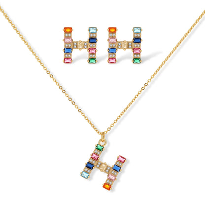 Letter H jewelry set featuring geometric crystal design in gold and white gold plated finish with adjustable chain necklace
