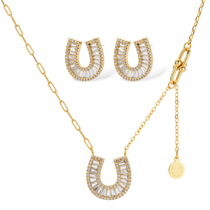Sparkling horseshoe-shaped jewelry set with AAA cubic zirconia in gold-plated and white gold finishes on cream background.